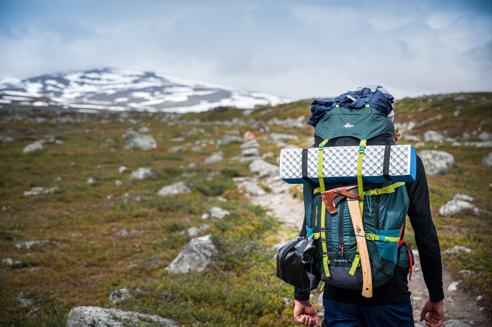 Back view of unrecognizable traveler with backpack with hiking equipment walking up on narrow path – gaia gps caltopo farout